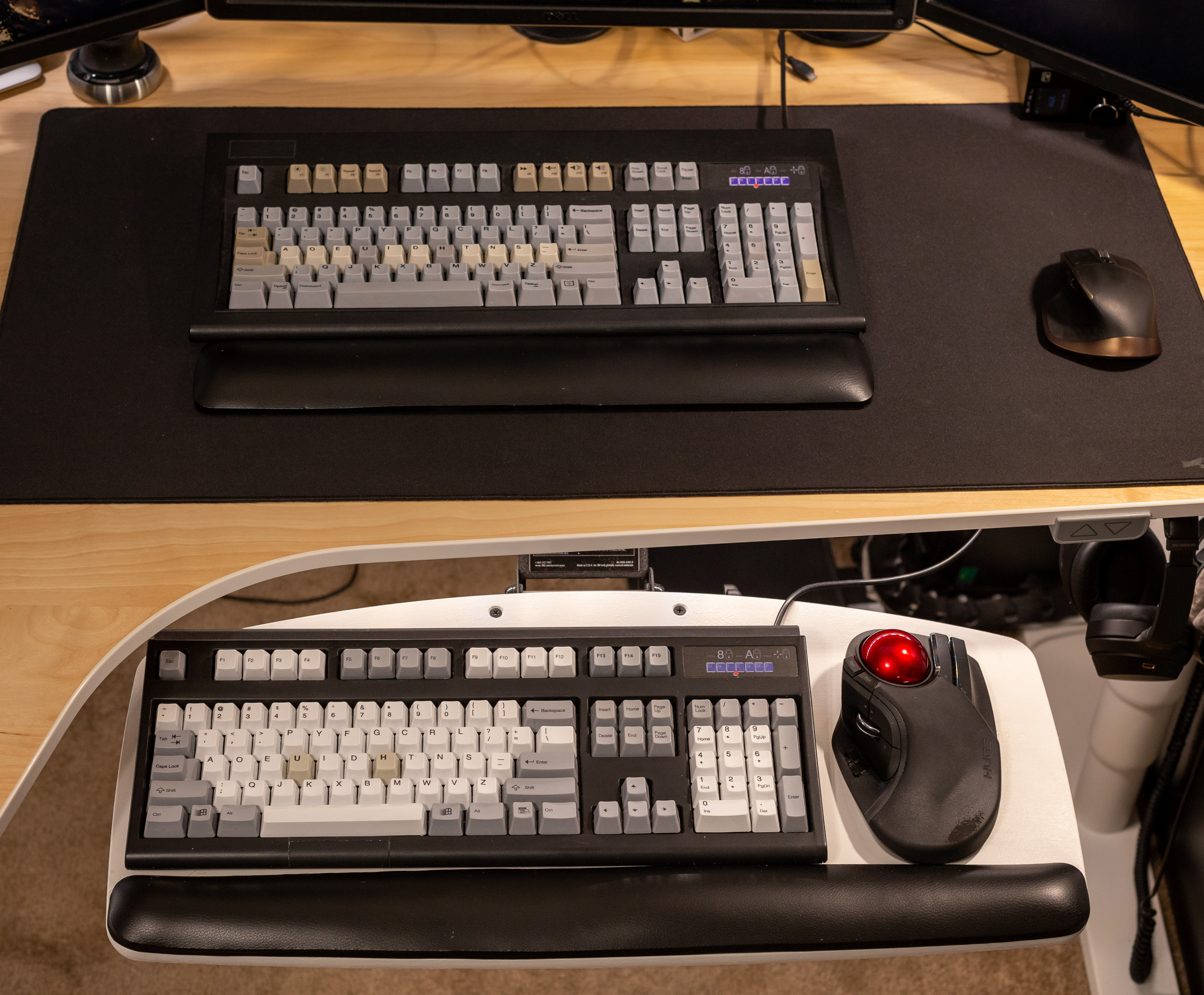 Keyboards on desk and keyboard tray